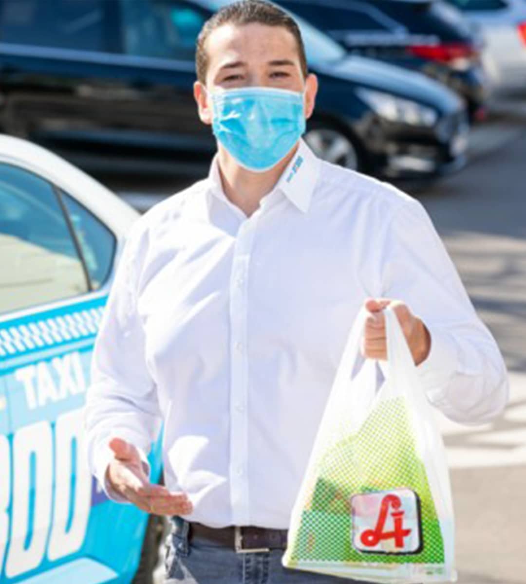 Taxilenker mit MNS-Maske und Einkäufen